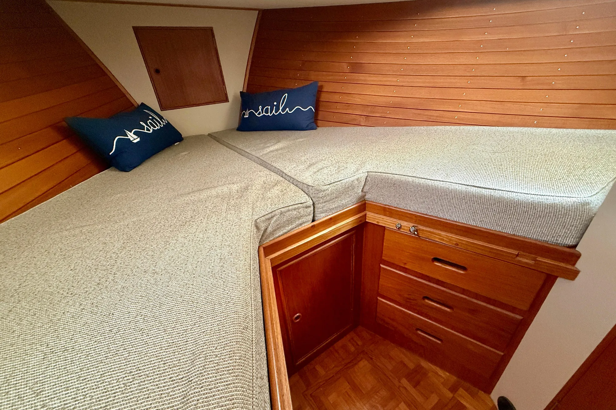Cozy cabin interior of 1982 Grand Banks 42 Classic with wooden finish and twin beds.