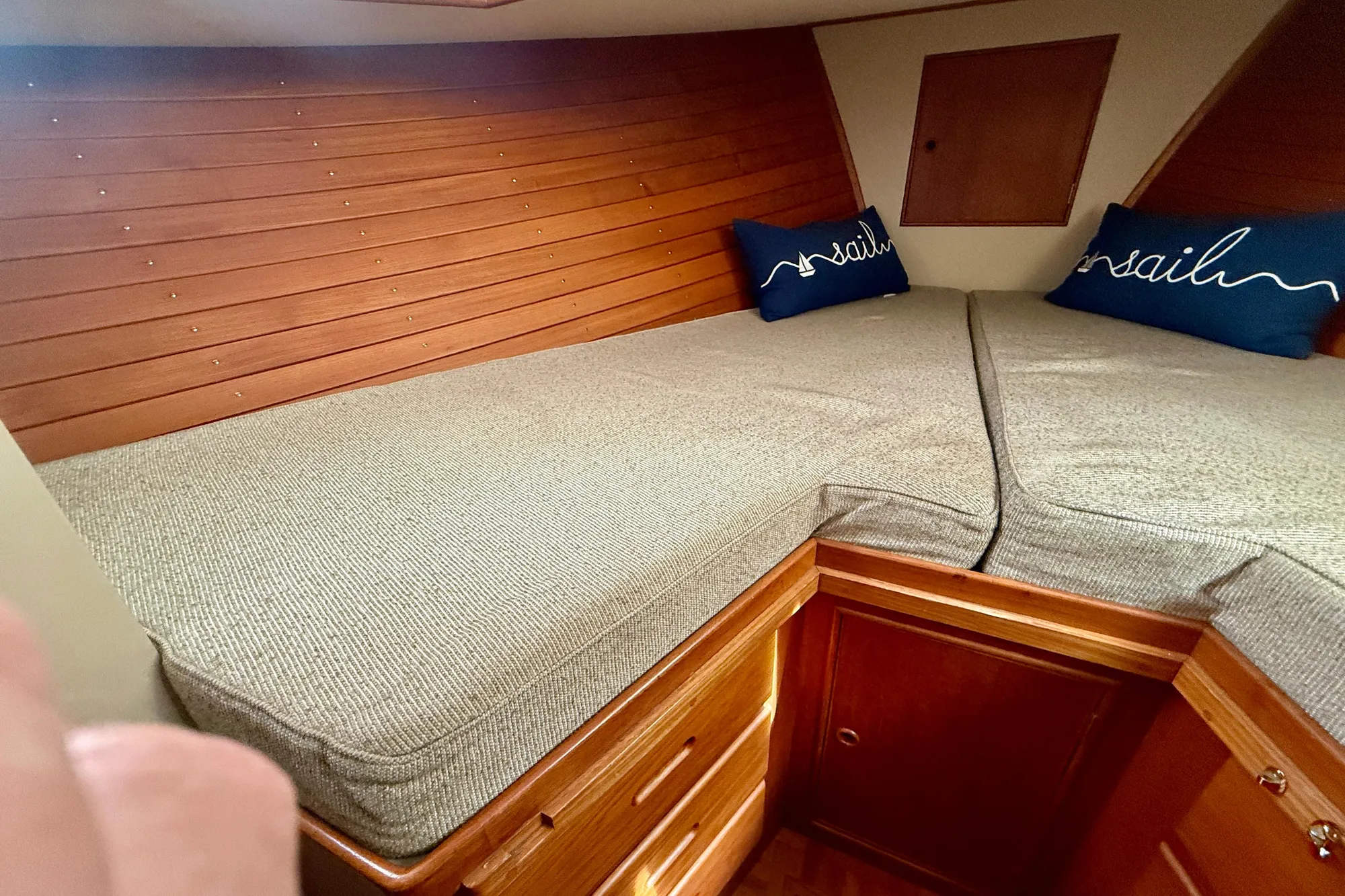 Cozy cabin interior of 1982 Grand Banks 42 Classic with wooden paneling and twin beds.