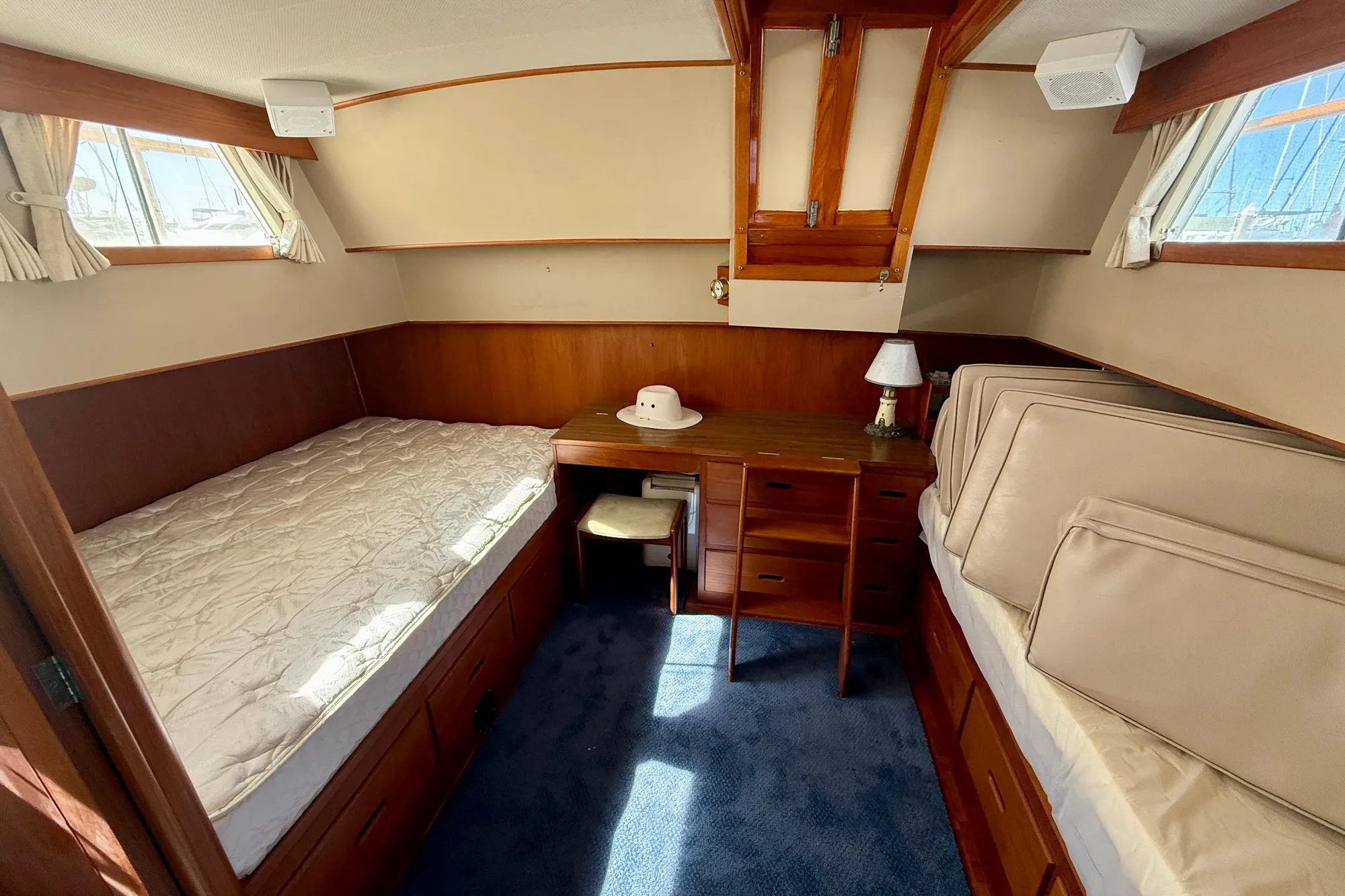1982 Grand Banks 42 Classic cabin with twin beds, wooden furniture, and nautical decor.
