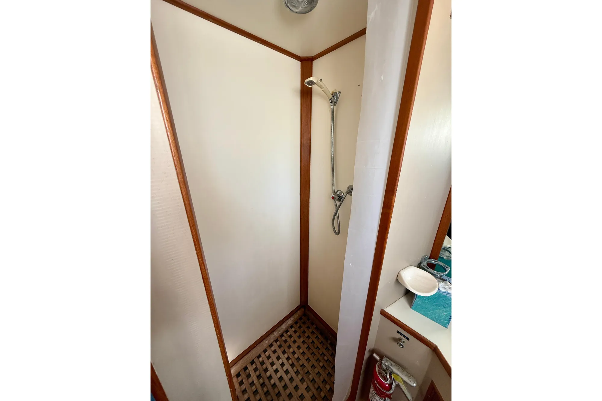Shower area in 1982 Grand Banks 42 Classic yacht with wooden accents.