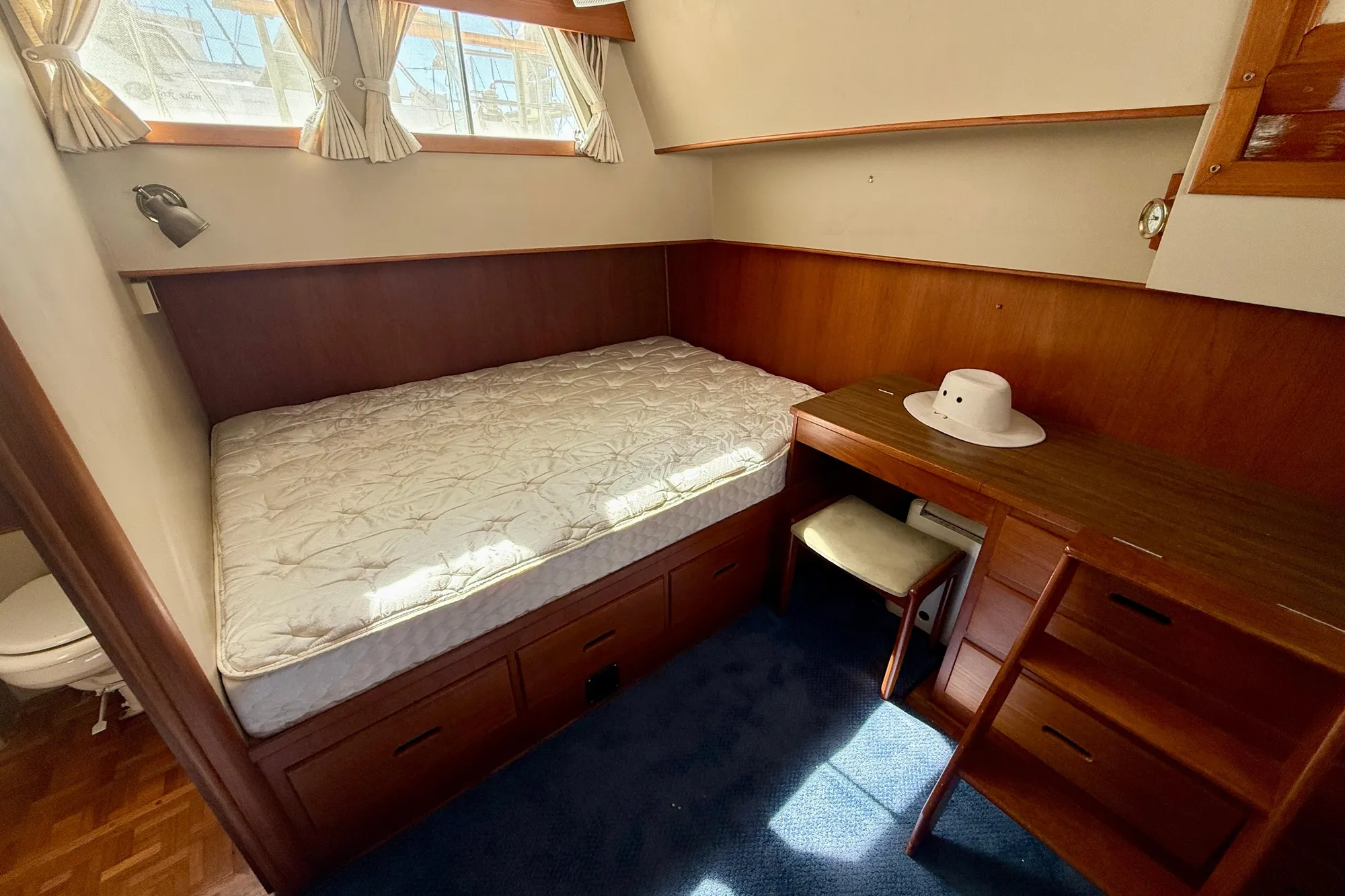 1982 Grand Banks 42 Classic cabin with bed, desk, and natural light.