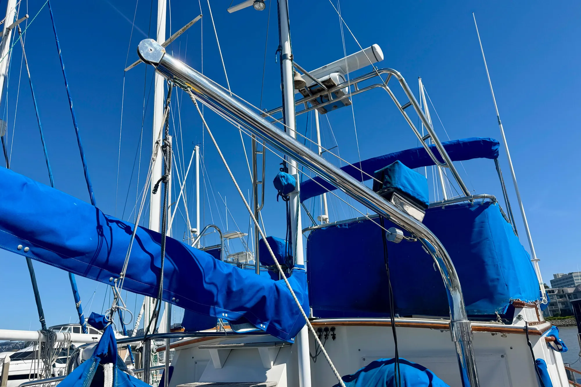 1982 Grand Banks 42 Classic yacht with blue covers and clear sky background.