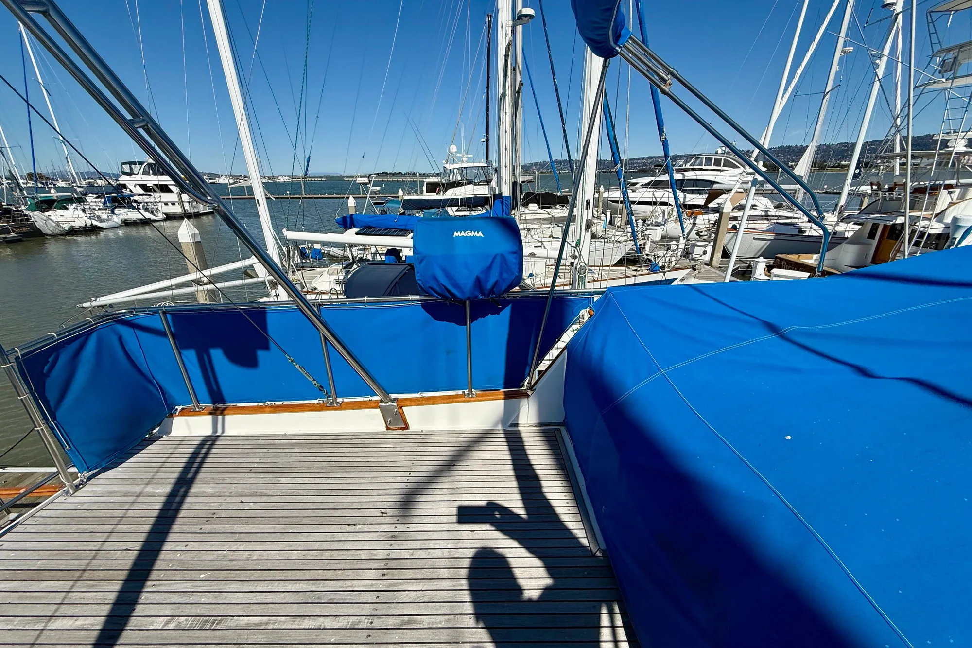1982 Grand Banks 42 Classic yacht with blue covers docked at a marina.