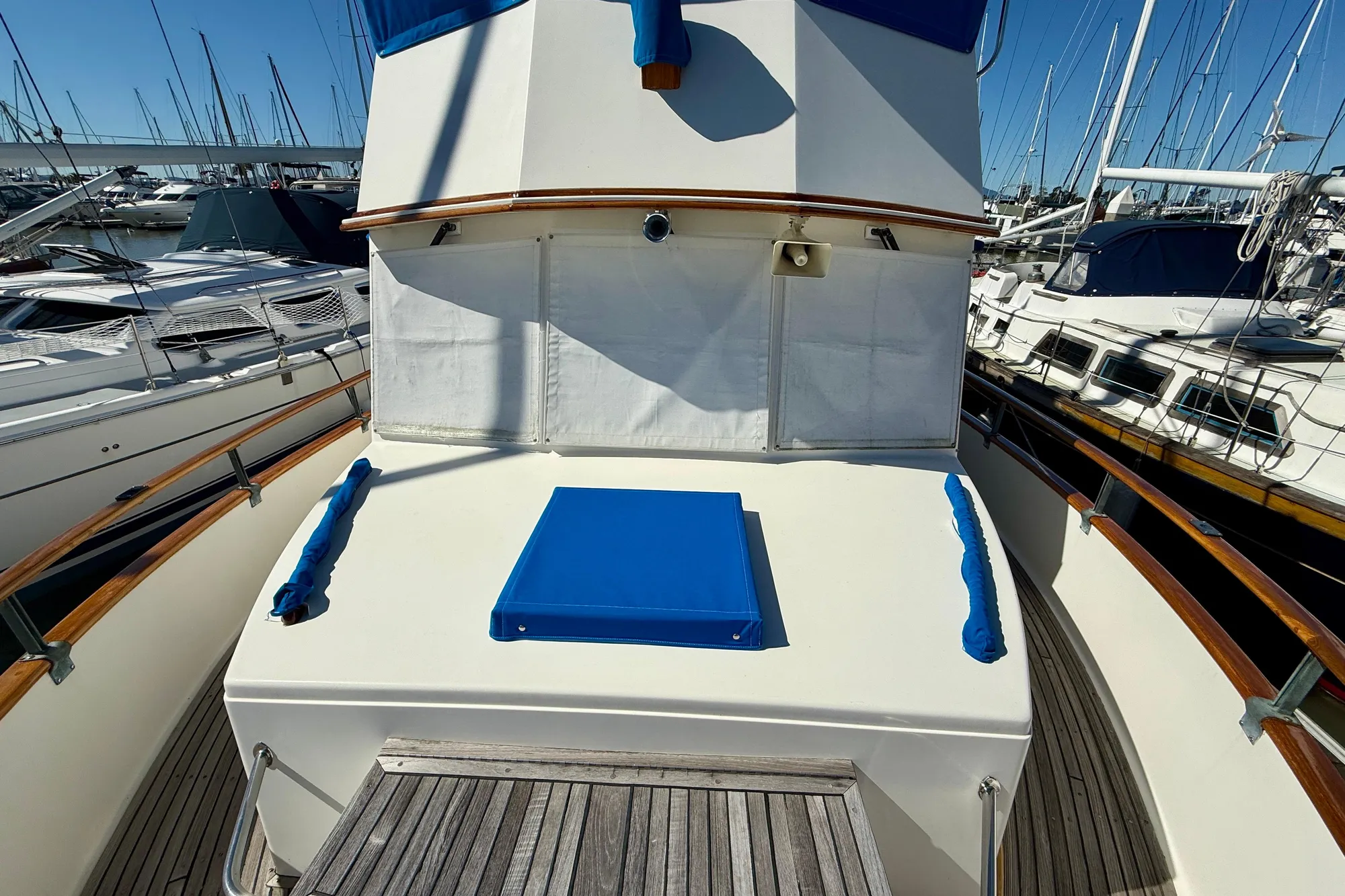1982 Grand Banks 42 Classic yacht deck with blue accents, docked in marina.