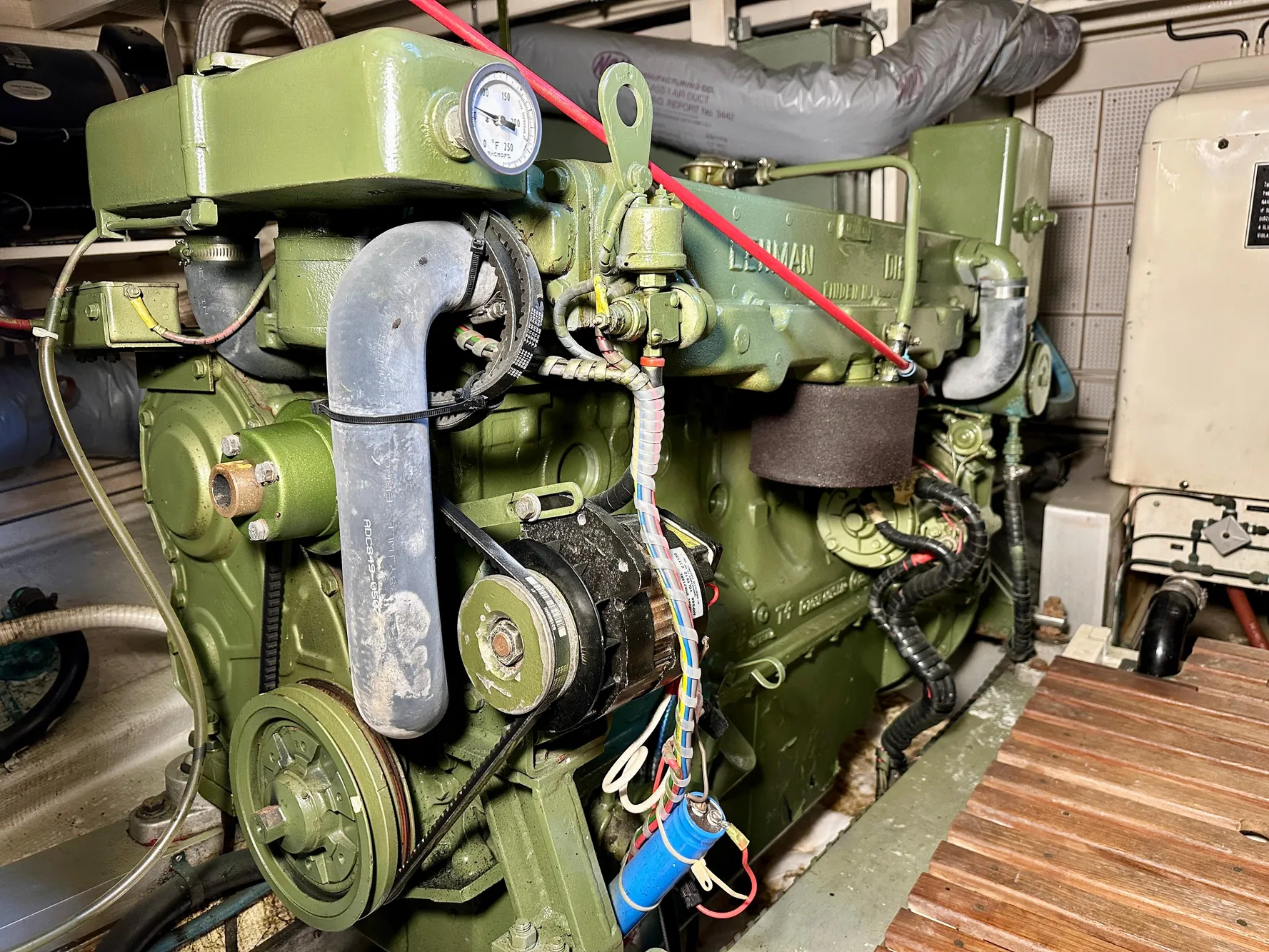 Engine room of a 1982 Grand Banks Classic boat, featuring a green marine engine.