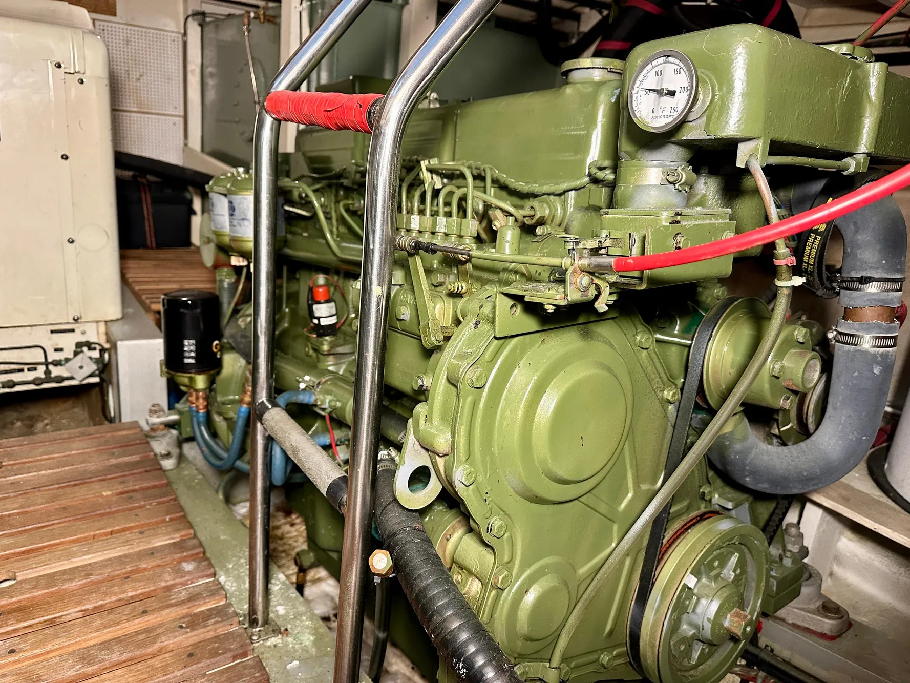 Engine room of a 1982 Grand Banks Classic boat, showcasing a green marine engine.
