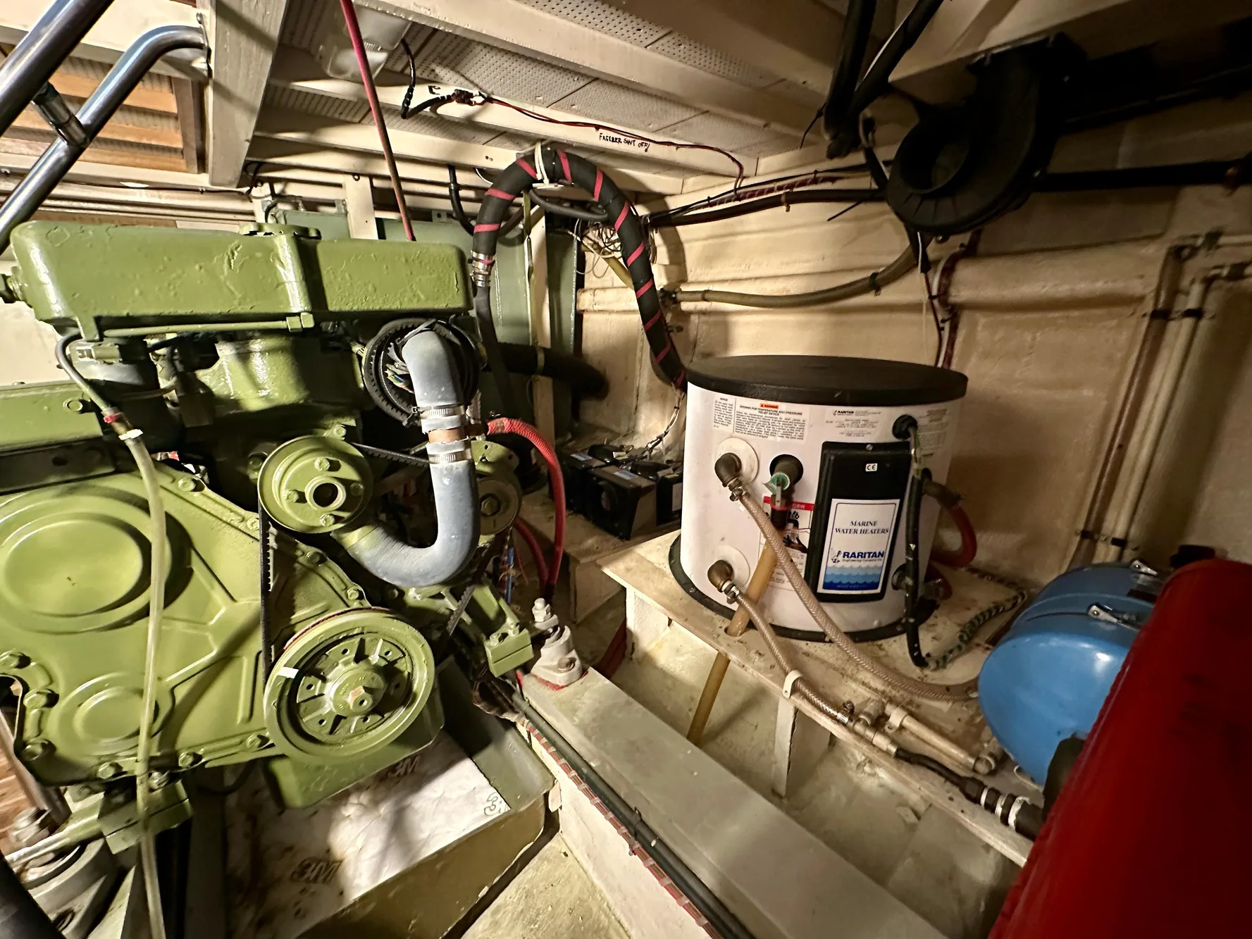 Engine room of a 1982 Grand Banks Classic boat, featuring machinery and piping.