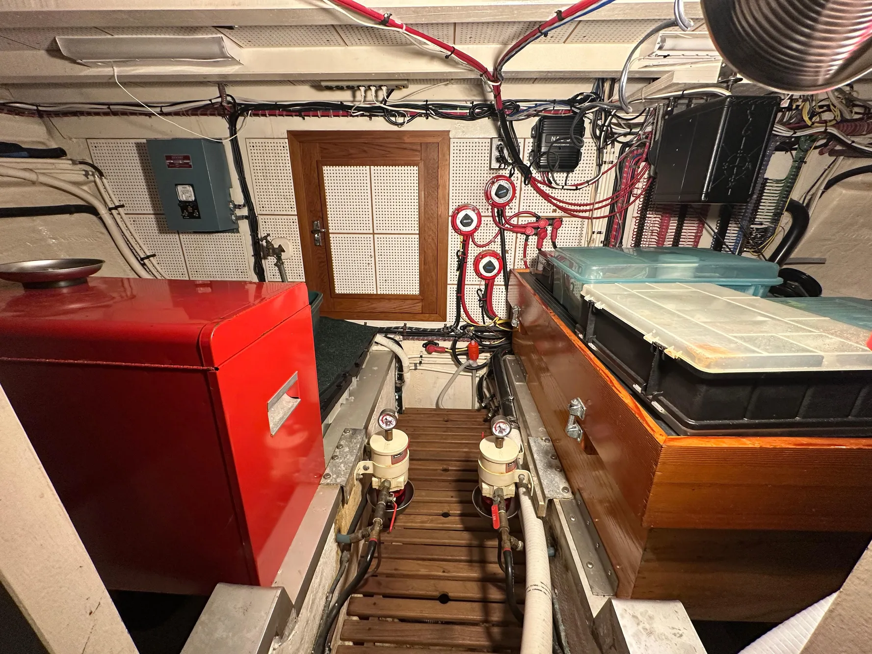Engine room of 1982 Grand Banks Classic boat with equipment and wiring.