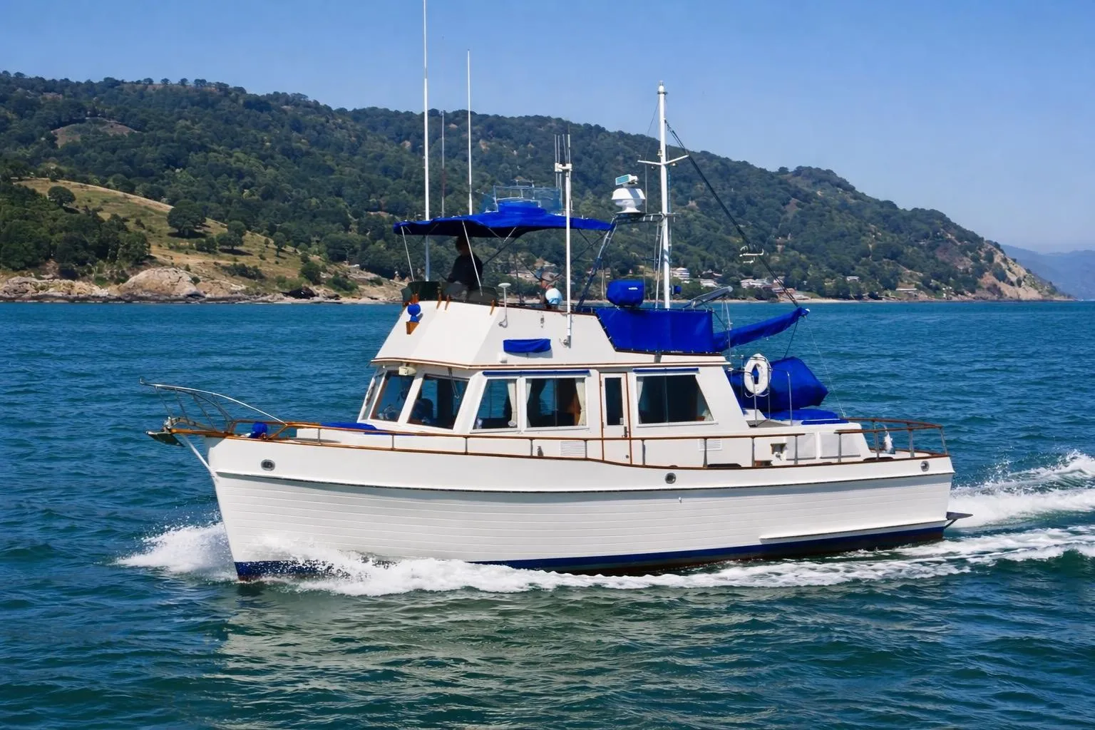 1982 Grand Banks Classic yacht cruising on scenic blue waters.