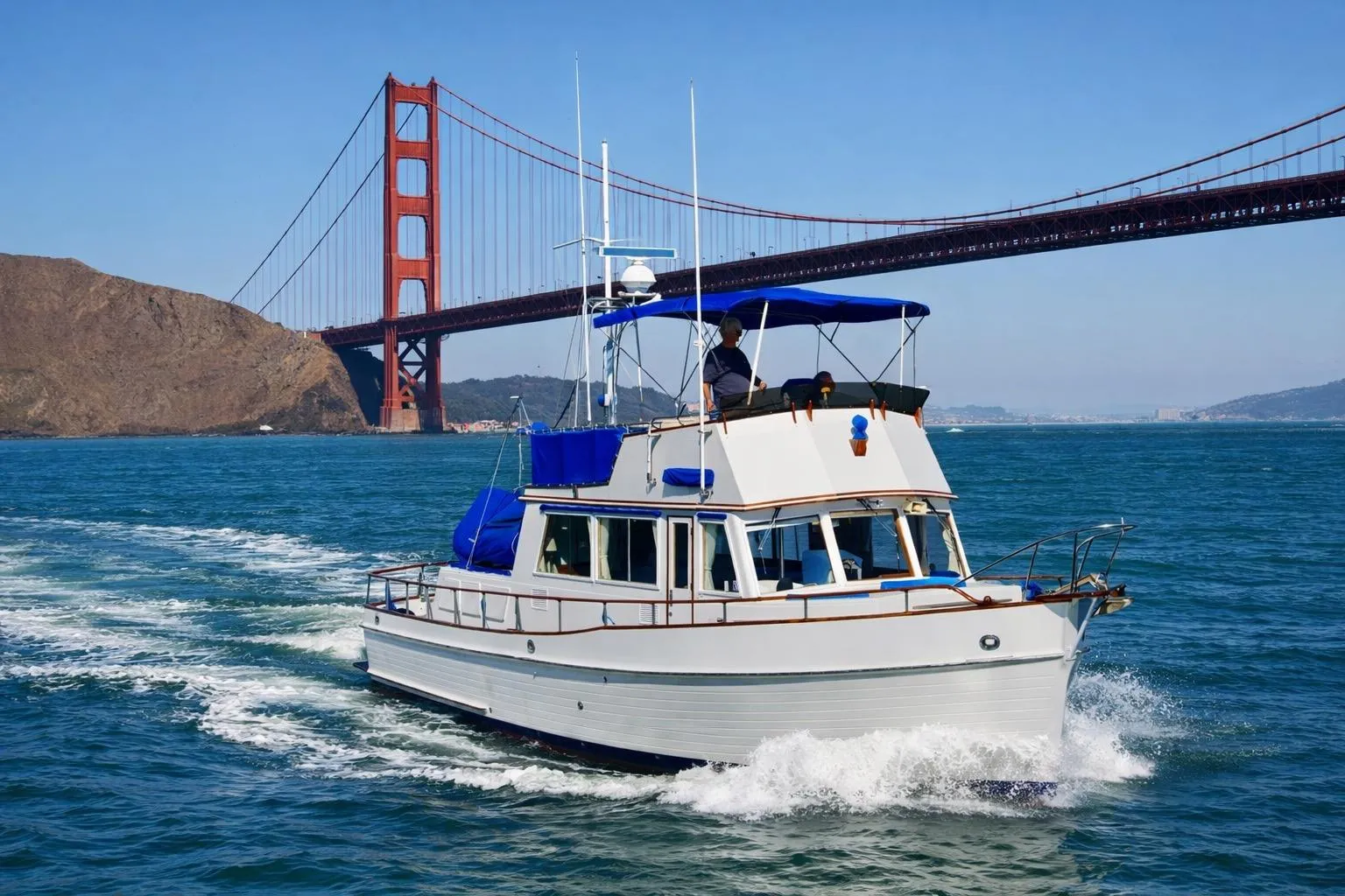 1982 Grand Banks Classic yacht cruising near Golden Gate Bridge, San Francisco.