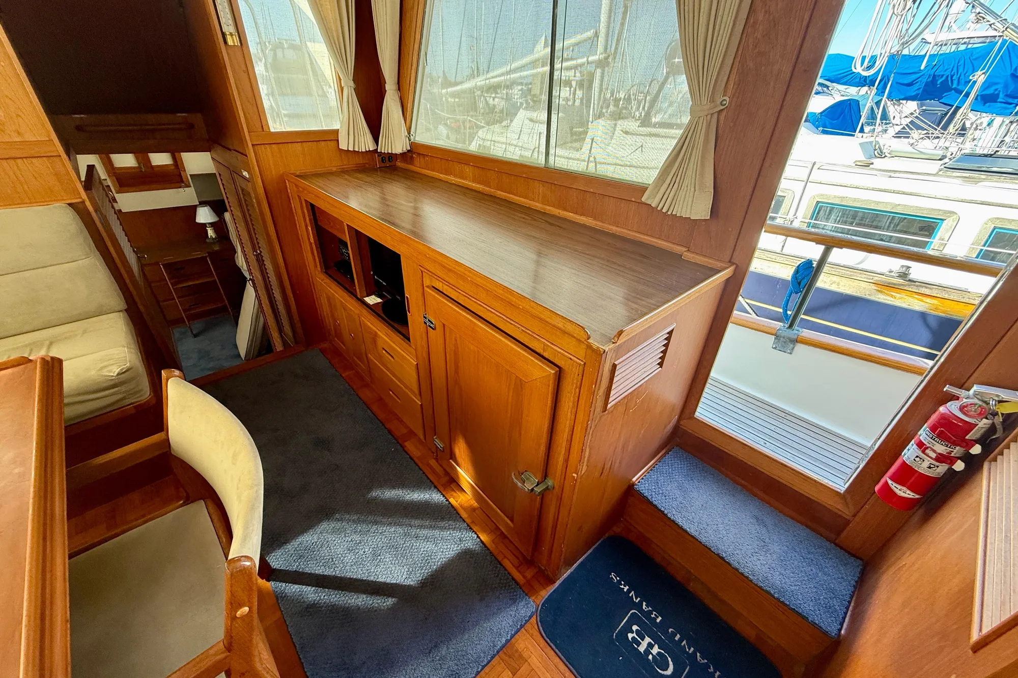 Interior of 1982 Grand Banks Classic yacht with wooden cabinetry and nautical decor.