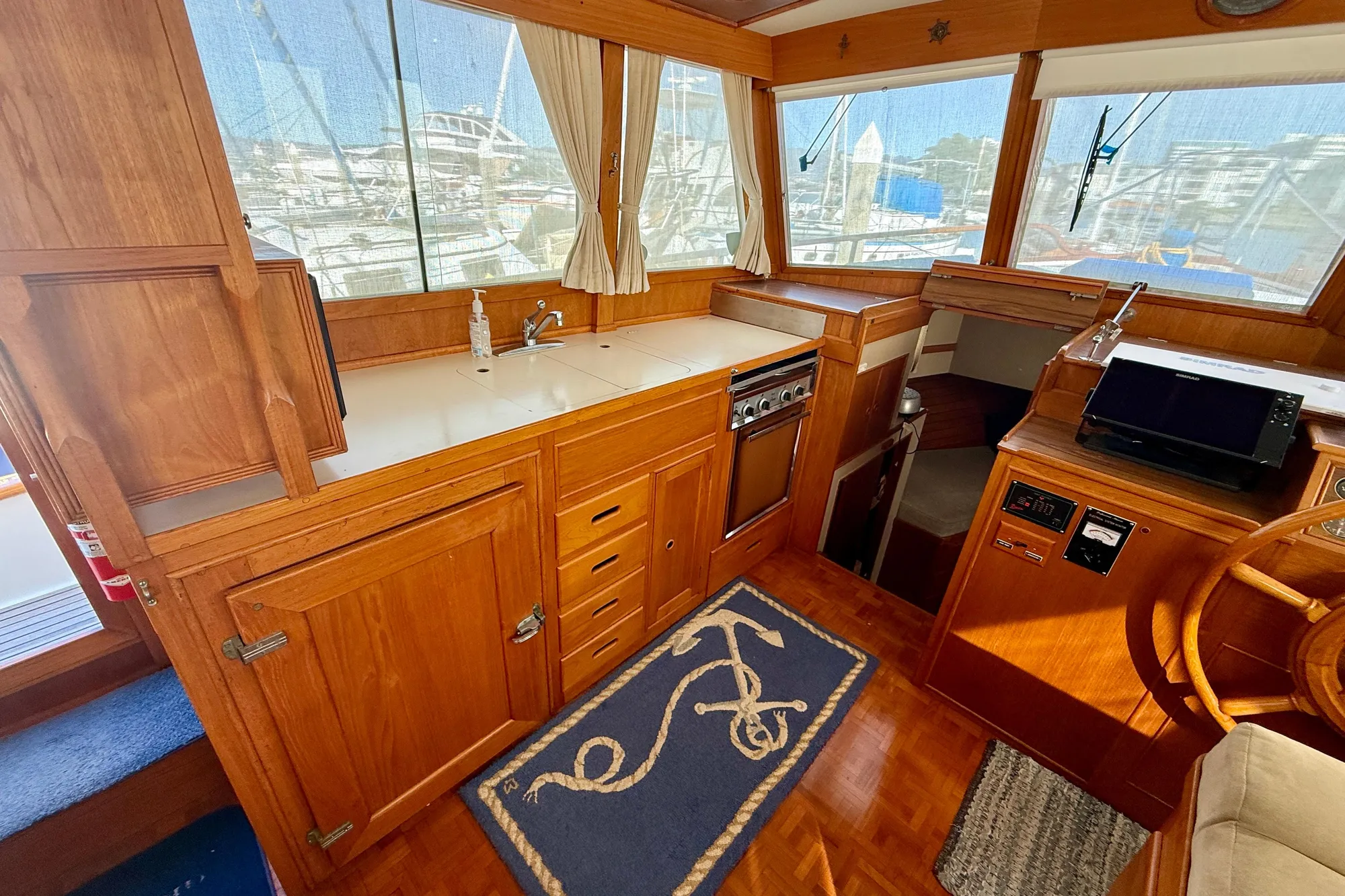 1982 Grand Banks Classic yacht interior with wooden cabinetry and nautical decor.