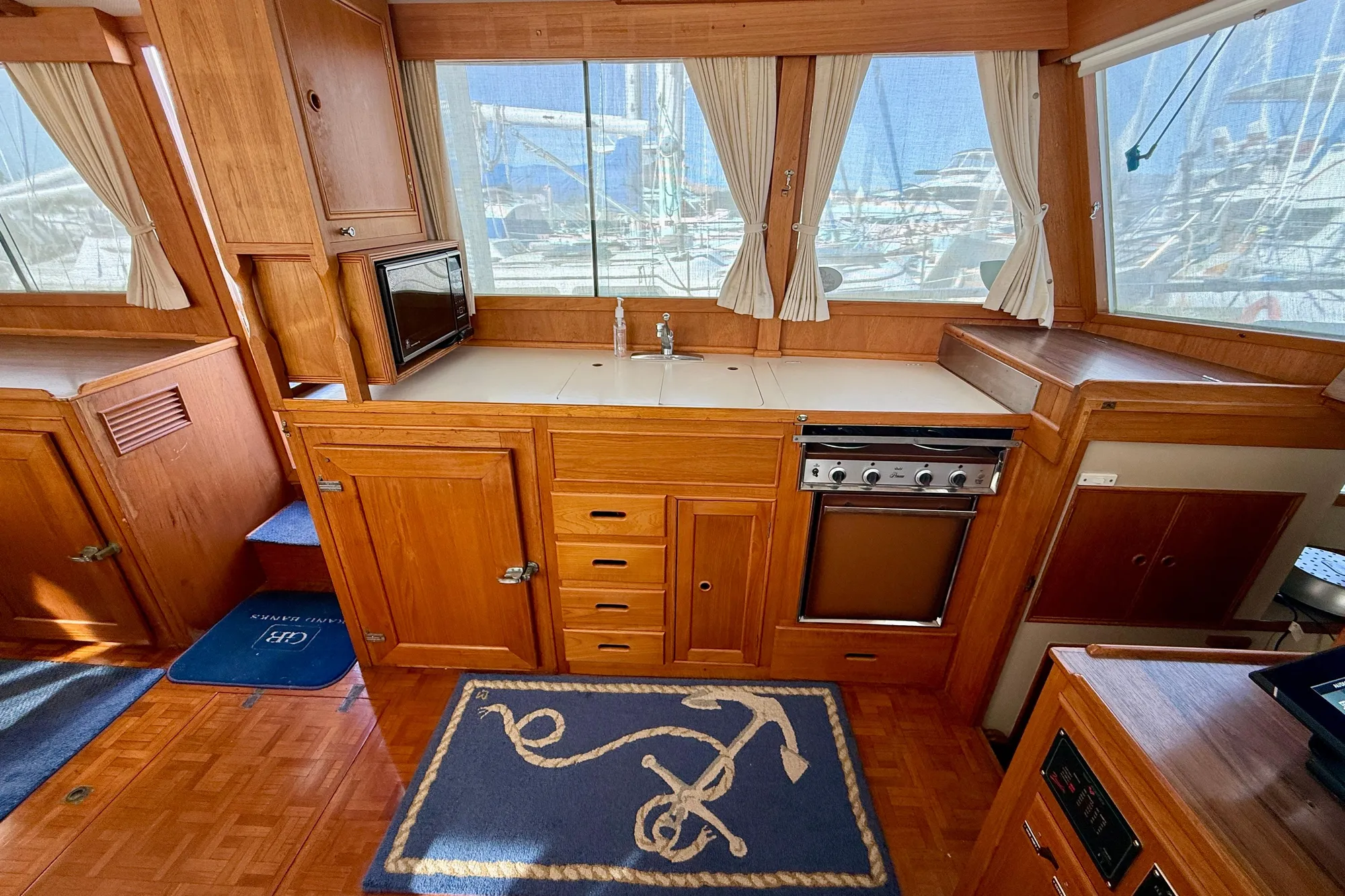 1982 Grand Banks Classic yacht interior with wooden cabinetry and nautical-themed decor.