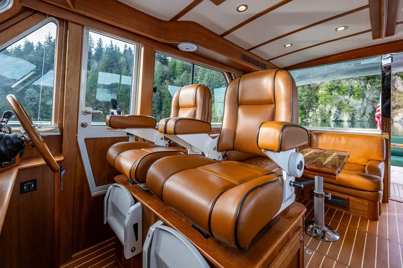 Sea Song Yacht Photos Pics Luxurious interior of 2019 Sabre 48 Salon Express yacht with leather seating and wooden finishes.