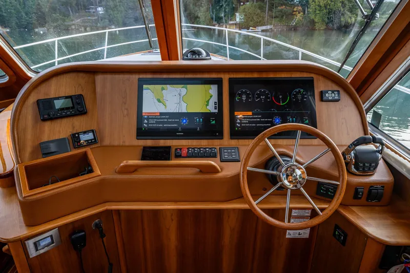 Sea Song Yacht Photos Pics 2019 Sabre 48 Salon Express helm with dual navigation screens and wooden steering wheel.