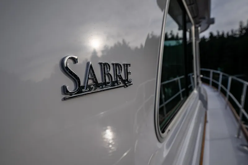 Sea Song Yacht Photos Pics 2019 Sabre 48 Salon Express yacht with logo, sleek design, and reflective surface.