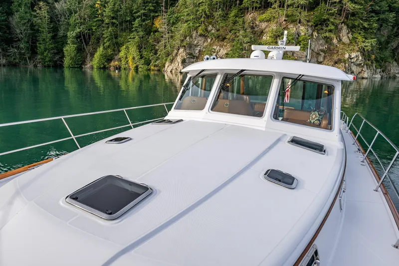 Sea Song Yacht Photos Pics 2019 Sabre 48 Salon Express yacht on serene lake with forested backdrop.