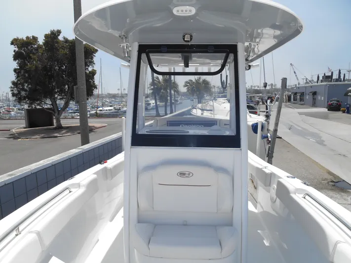  Yacht Photos Pics 2019 Sea Hunt Ultra 235 SE boat docked at marina, featuring center console and seating.