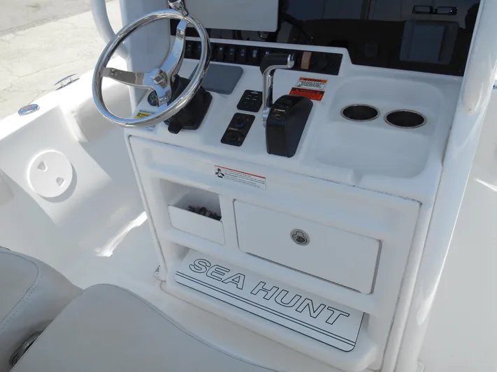  Yacht Photos Pics 2019 Sea Hunt Ultra 235 SE boat console with steering wheel and controls.
