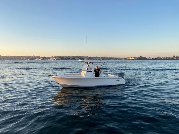 Yacht Photos Pics 2019 Sea Hunt Ultra 235 SE boat on calm water at sunset.