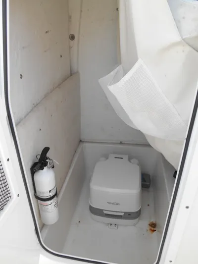  Yacht Photos Pics 2019 Sea Hunt Ultra 235 SE boat interior with portable toilet and fire extinguisher.