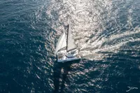 Aerial view of 2025 Nautitech 44 Open sailing on shimmering ocean waters.