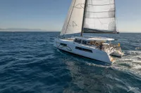 Sailing catamaran Nautitech 44 Open 2026 gliding on open sea under clear skies.