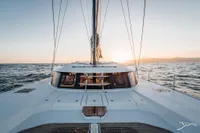 2025 Nautitech 44 Open catamaran sailing at sunset on open sea.