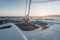 2025 Nautitech 44 Open catamaran sailing at sunset on open sea.