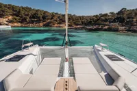 2026 Nautitech 44 Open catamaran in serene turquoise waters, featuring spacious deck and lounging area.