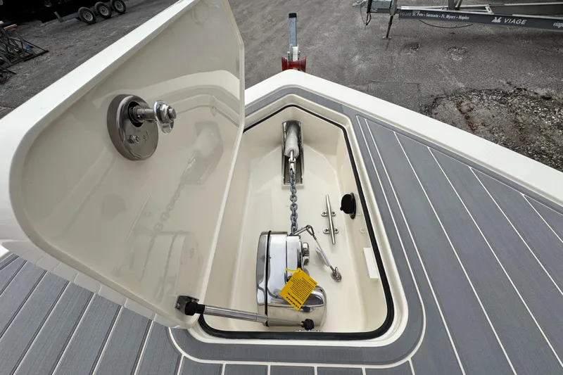  Yacht Photos Pics Open anchor locker on 2025 Scout 281 XSS boat, showcasing chain and winch.