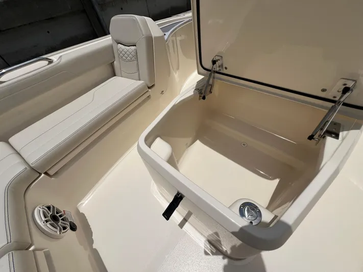  Yacht Photos Pics 2025 Scout 281 XSS boat interior with open storage compartment and cushioned seating.