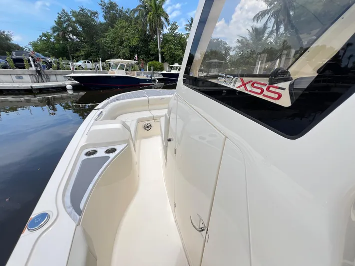  Yacht Photos Pics 2025 Scout 281 XSS boat docked, showcasing sleek design and spacious deck.