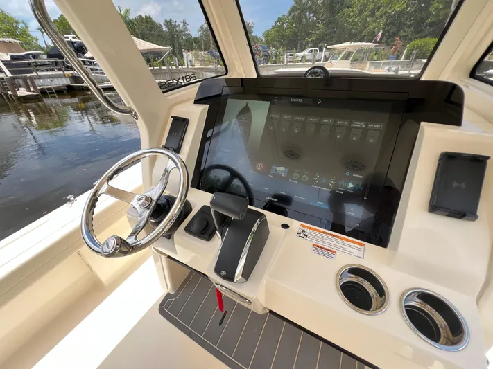  Yacht Photos Pics 2025 Scout 281 XSS boat dashboard with touchscreen controls and steering wheel.