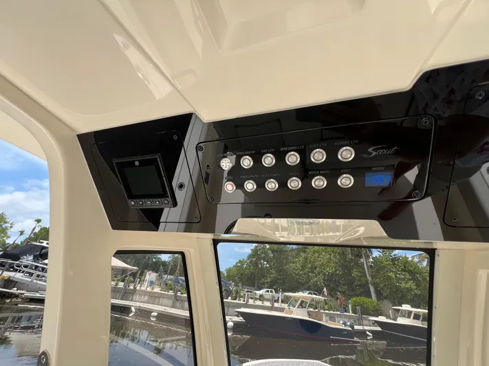  Yacht Photos Pics Control panel of 2025 Scout 281 XSS boat with various switches and display.