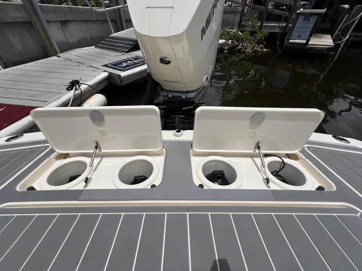  Yacht Photos Pics 2025 Scout 281 XSS boat with open storage compartments at the dock.