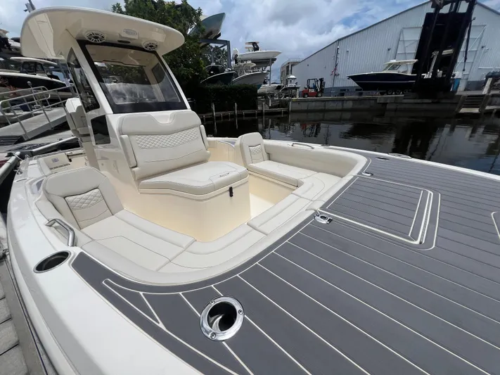  Yacht Photos Pics 2025 Scout 281 XSS boat with luxurious seating and sleek design at a marina.