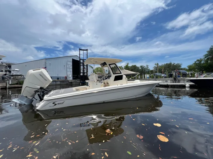  Yacht Photos Pics 2025 Scout 281 XSS boat docked on calm water under a partly cloudy sky.