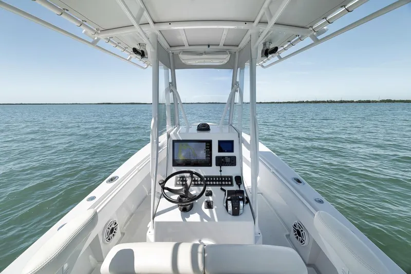  Yacht Photos Pics 2004 Contender 25 Tournament boat interior with steering console on open water.