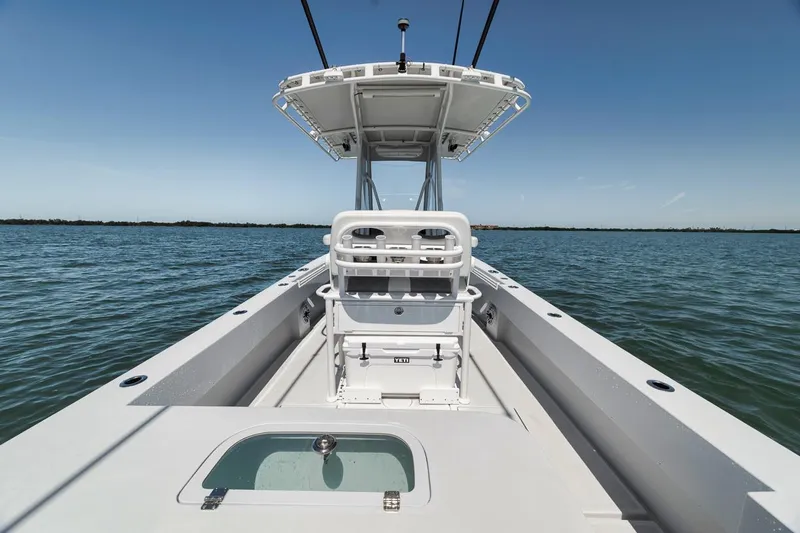  Yacht Photos Pics 2004 Contender 25 Tournament boat on calm water, featuring a center console and open deck.