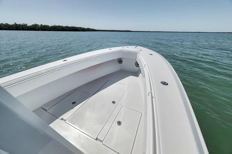  Yacht Photos Pics 2004 Contender 25 Tournament boat on calm water, showcasing spacious deck and sleek design.