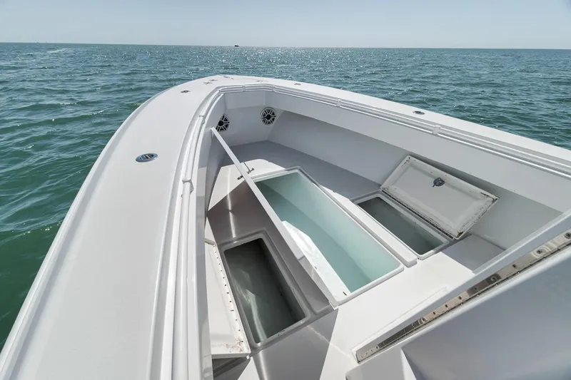  Yacht Photos Pics 2004 Contender 25 Tournament boat on open water, showcasing storage compartments.