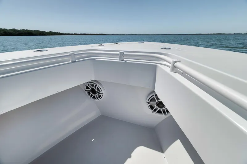  Yacht Photos Pics 2004 Contender 25 Tournament boat bow with speakers, on calm water.