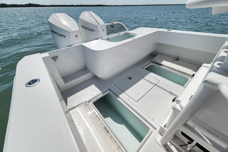  Yacht Photos Pics 2004 Contender 25 Tournament boat with dual Mercury engines on open water.