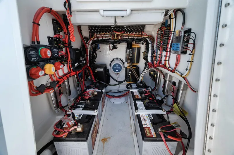  Yacht Photos Pics Electrical system inside a 2004 Contender 25 Tournament boat, featuring batteries and wiring.