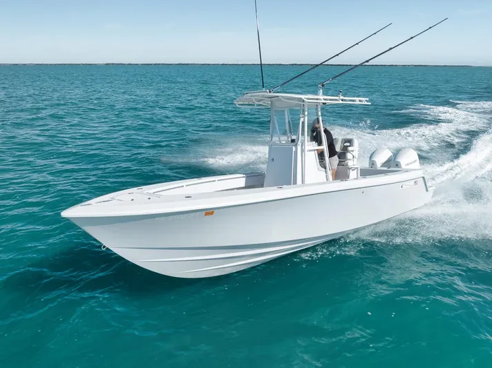  Yacht Photos Pics 2004 Contender 25 Tournament boat cruising on clear blue ocean waters.