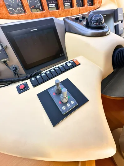 Andiamo Yacht Photos Pics Control panel of a 2010 Azimut 55E yacht with navigation instruments and joysticks.
