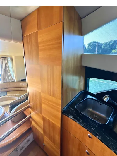 Andiamo Yacht Photos Pics Luxurious interior of 2010 Azimut 55E yacht with wood paneling and sleek sink.