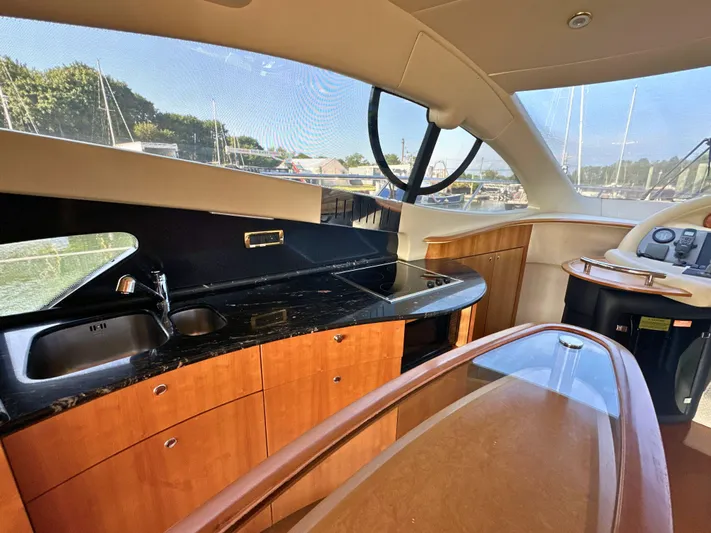 Andiamo Yacht Photos Pics Luxurious interior of 2010 Azimut 55E yacht with modern kitchen and sleek design.
