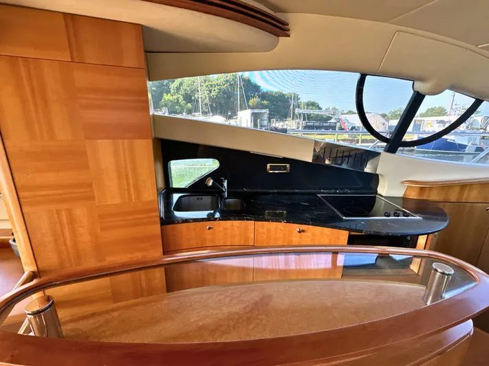 Andiamo Yacht Photos Pics Luxurious interior of 2010 Azimut 55E yacht with modern kitchen and wooden finishes.
